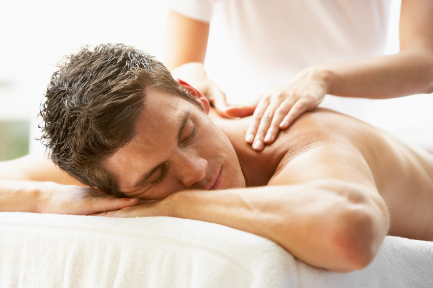 Young Man Enjoying Massage At Spa